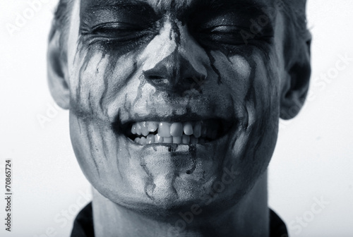portrait of a man in make-up Halloween. drawing a vampire on his