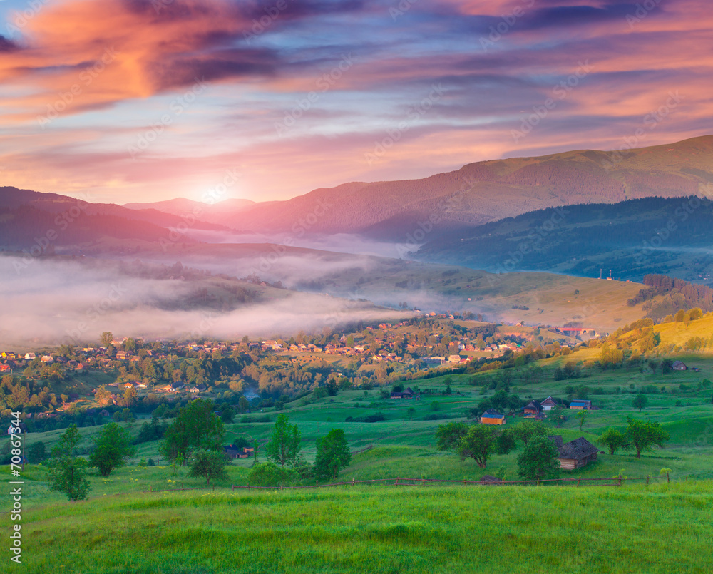 Colorful summer sunrise in the mountain village.