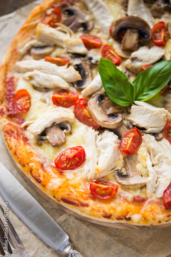 Pizza with chicken and mushrooms close up