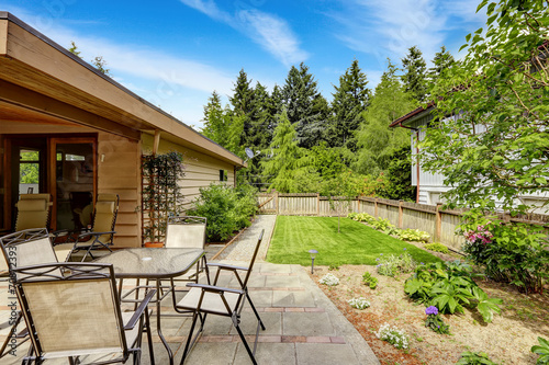 Walkout patio with concrete tile floor and table set