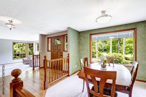 House interior. Entance hallway with balustrade and green dining