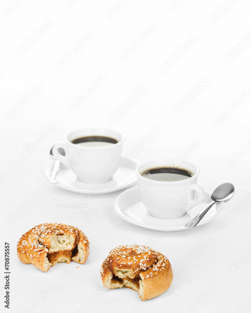 Two partially eaten cinnamon buns. Two partially eaten cinnamon buns.