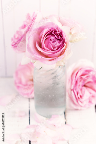 Roses on wooden background. © daffodilred