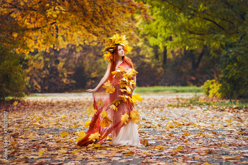 girl in yellow autumn leaves