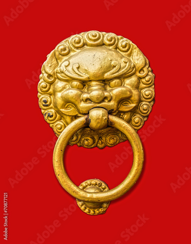 Metal door knocker in Chinese design isolated on red background