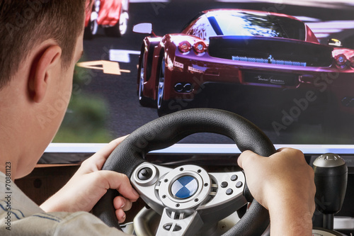 Teen playing in the race behind the wheel