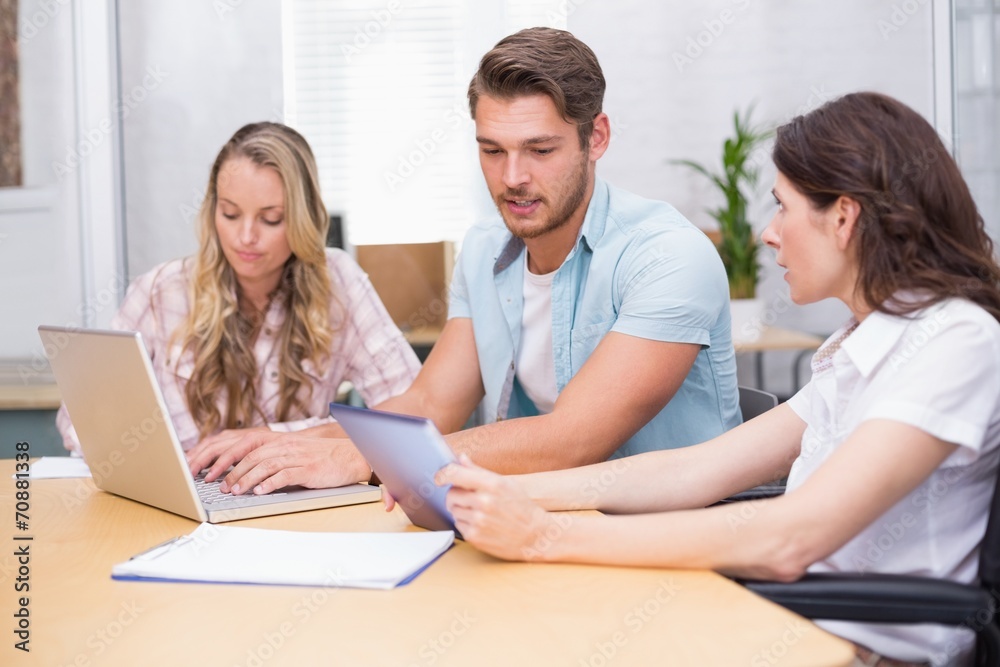 Business people using digital tablet and laptop in meeting Business people using digital tablet and laptop in meeting