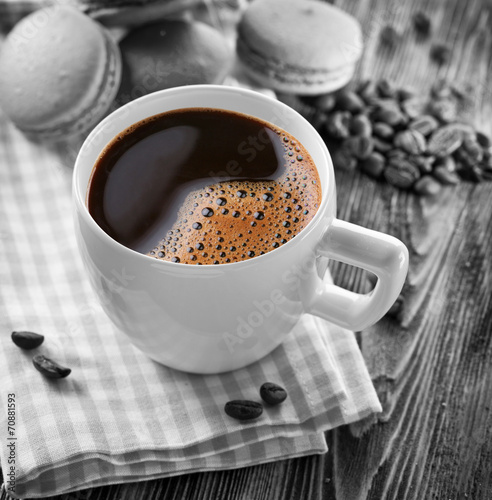 Cup of coffee and french macaron.