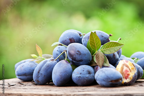 Plums on an old wooden table.
