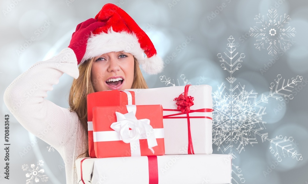 Composite image of festive blonde holding pile of gifts Composite image of festive blonde holding pile of gifts