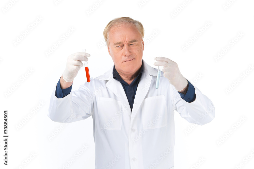 Man lab technician looks at test tubes. Man lab technician looks at test tubes.