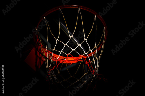 Basketball hoop on  black background with light effect © torsak