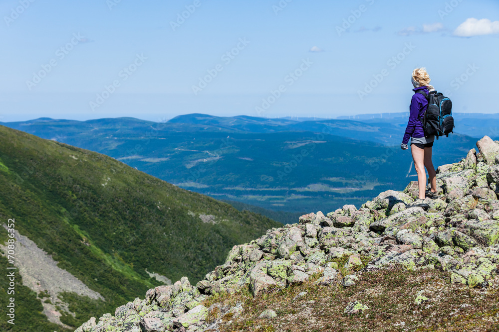 Young Woman Looking at the View From the Top of the Hill