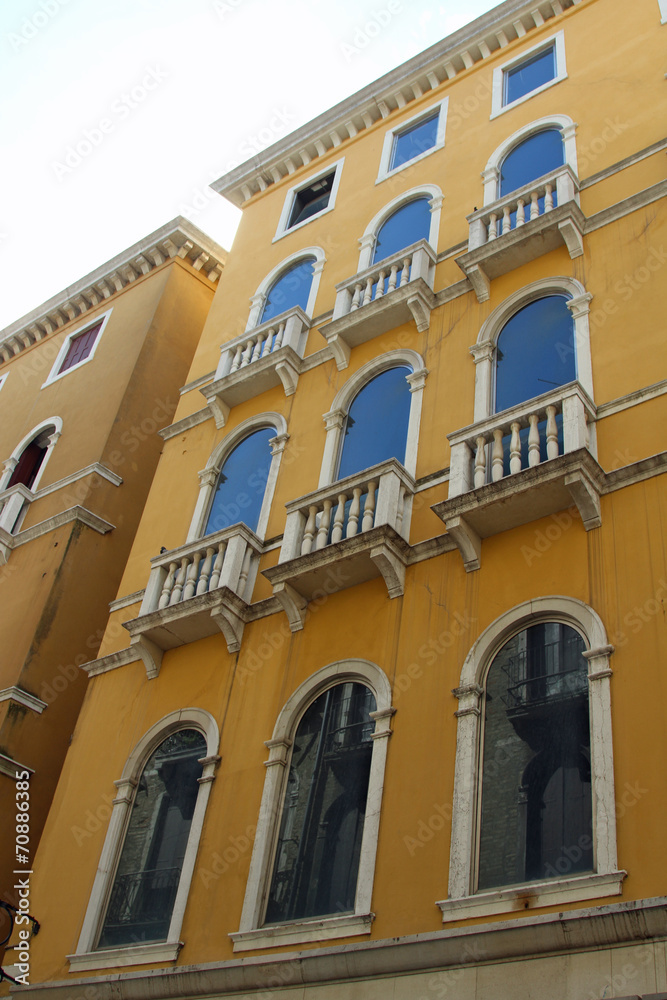 yellow facade with blue window of a prominent Venetian Palace in