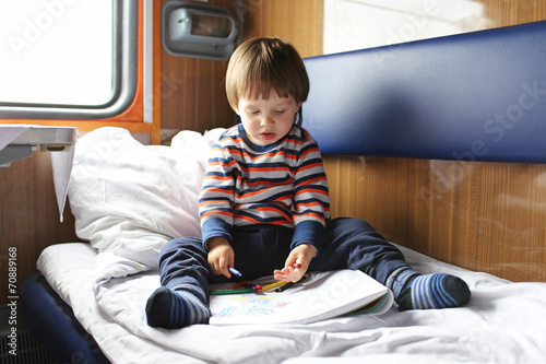 2 years boy painting in the train