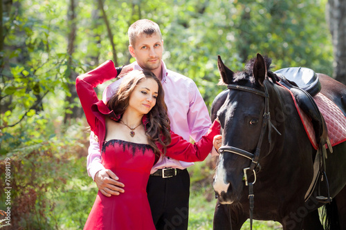 happy couple and horse