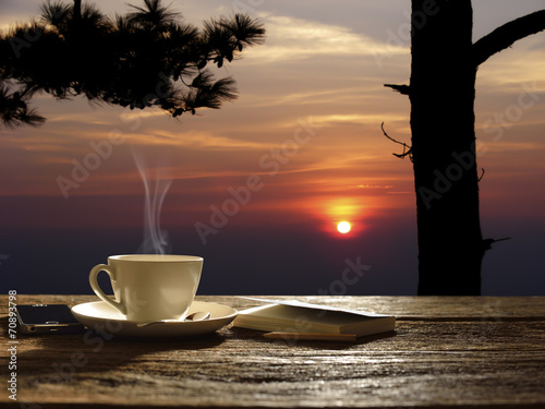 Morning cup of coffee with sunrise background