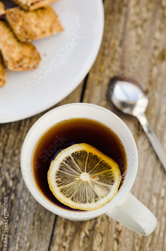 Cup of tea with lemon and cookies