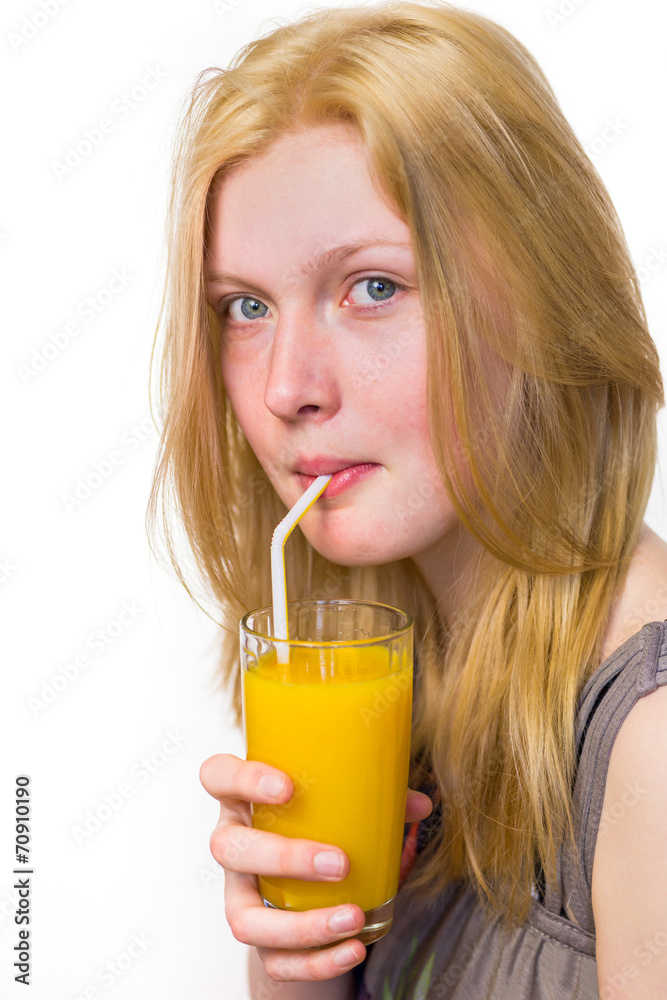 Blonde girl drinking orange juice with straw Blonde girl drinking orange juice with straw