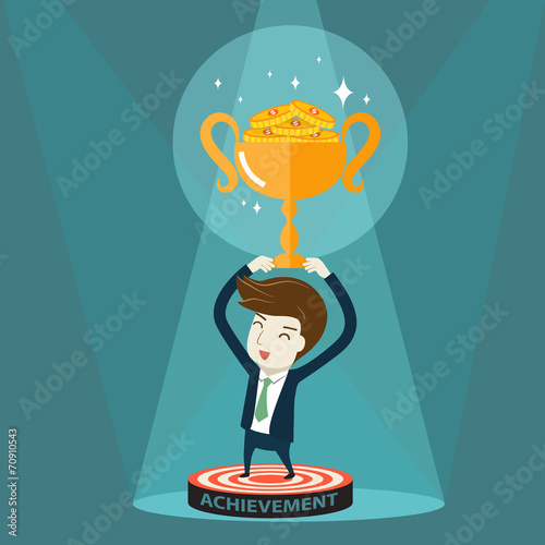 Businessman holding golden trophy