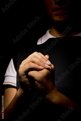 Praying woman Hands in black background