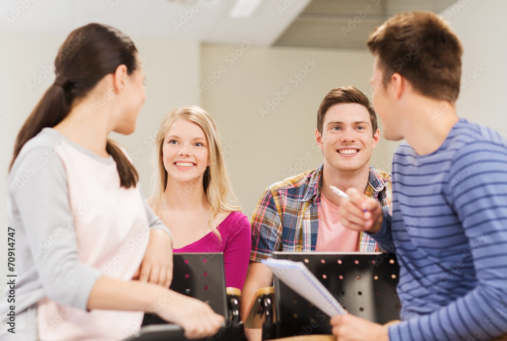 group of smiling students with notebook