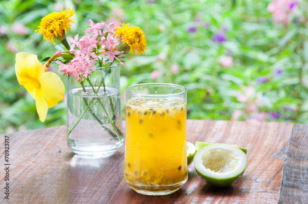 Fresh passion fruit juice with flower garden background Fresh passion fruit juice with flower garden background