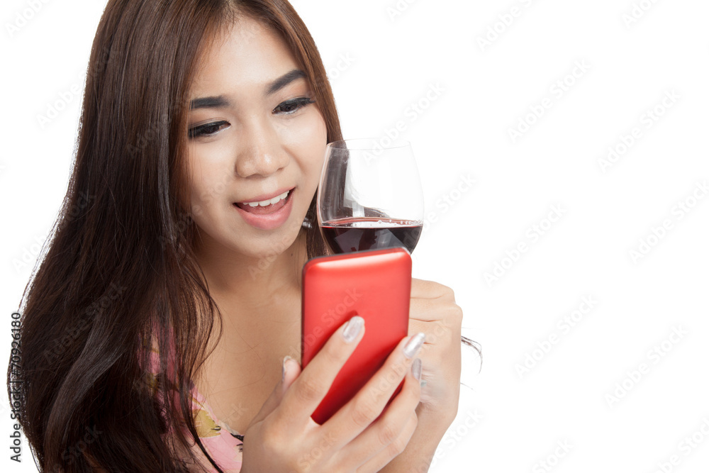 Beautiful Asian woman smile with cellphone and red wine Beautiful Asian woman smile with cellphone and red wine