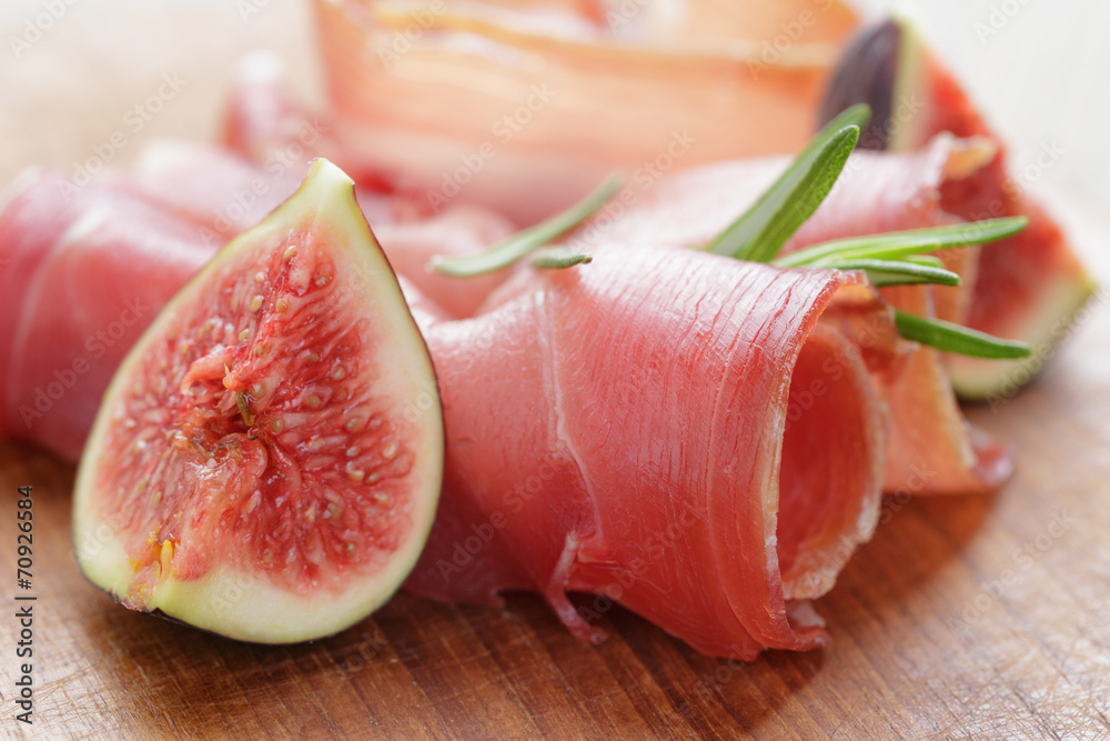 dried jamon slices with figs on wood table dried jamon slices with figs on wood table