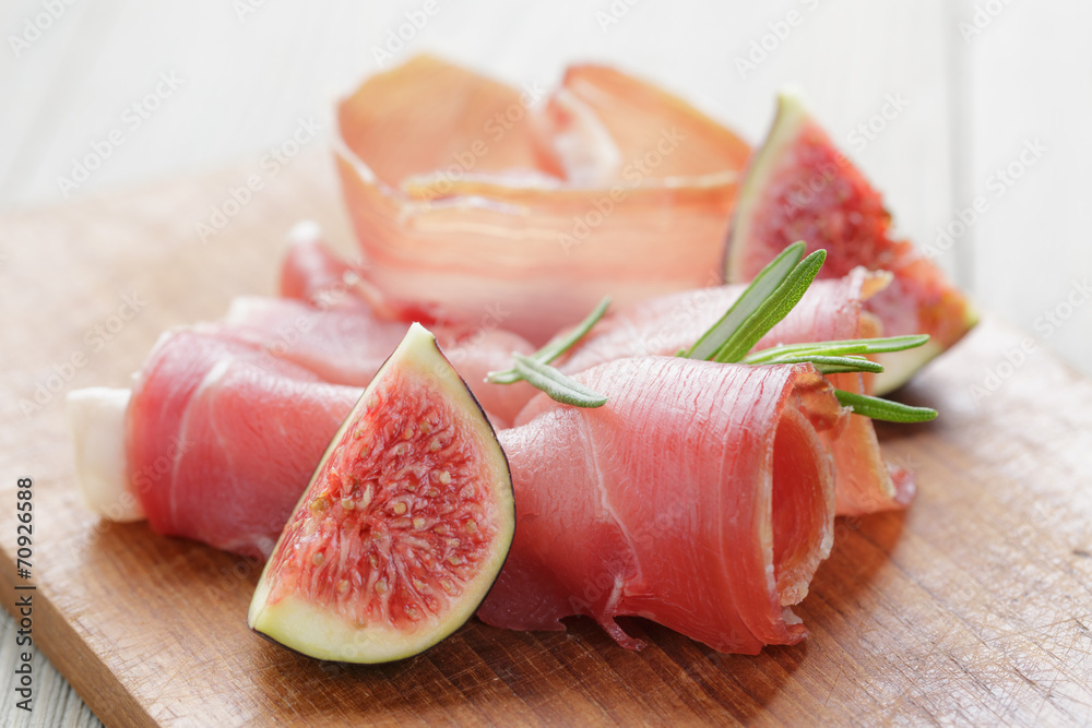 dried jamon slices with figs on wood table dried jamon slices with figs on wood table