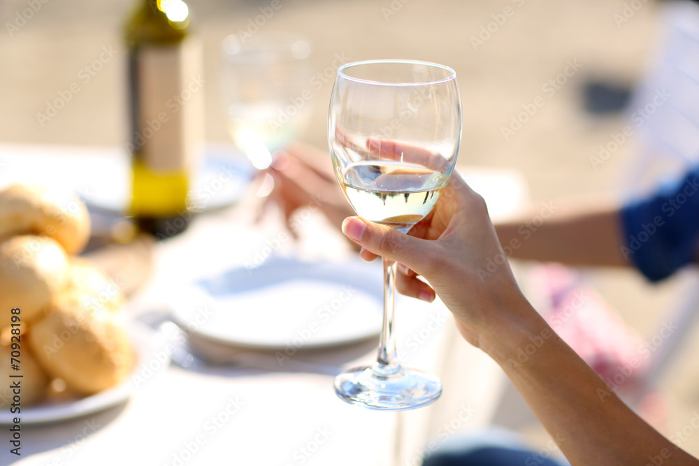Friends enjoying drink at outdoor restaurant. Hand with glass, Friends enjoying drink at outdoor restaurant. Hand with glass,