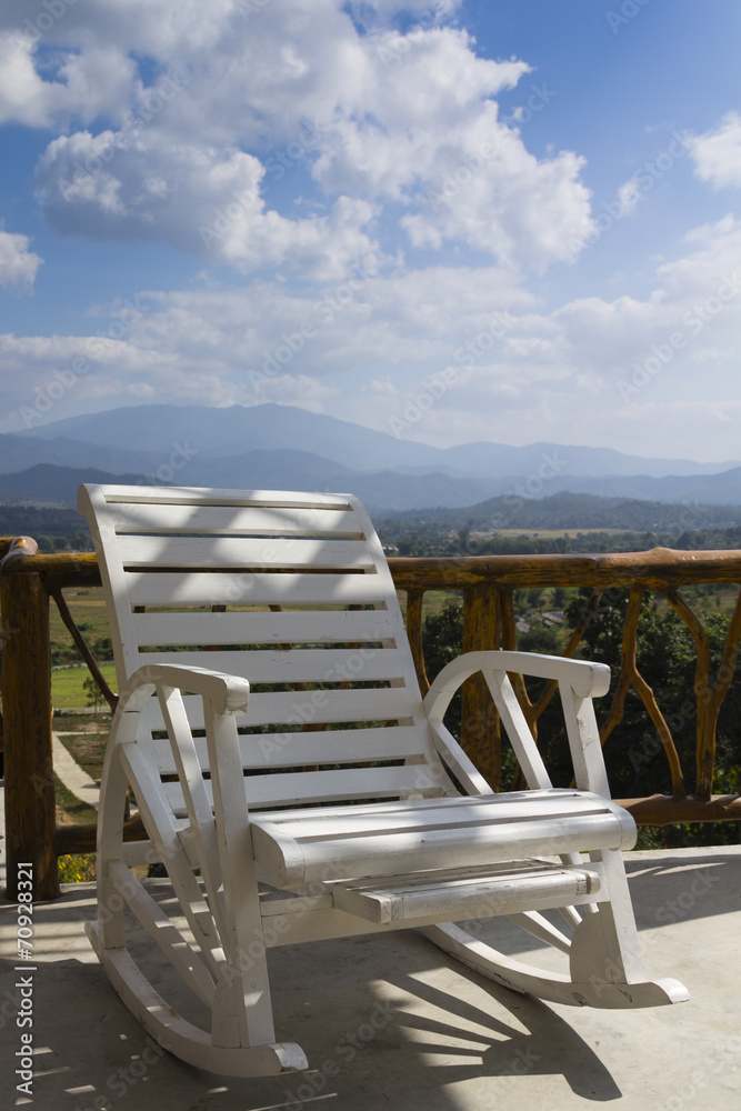 White wooden chair on the terrace in a bright holiday. White wooden chair on the terrace in a bright holiday.