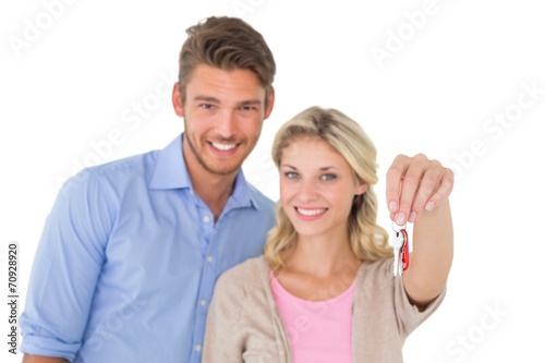 Happy attractive young couple holding new house key