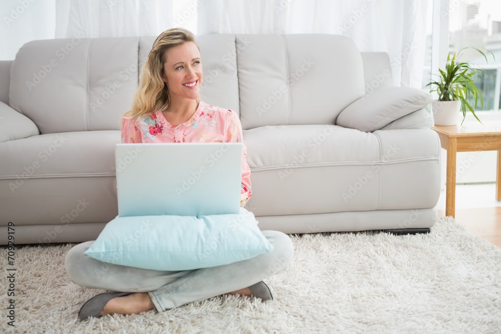 Beautiful blonde woman sitting on the floor using laptop Beautiful blonde woman sitting on the floor using laptop