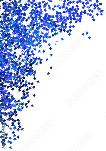 Blue stars in the form of confetti on white background
