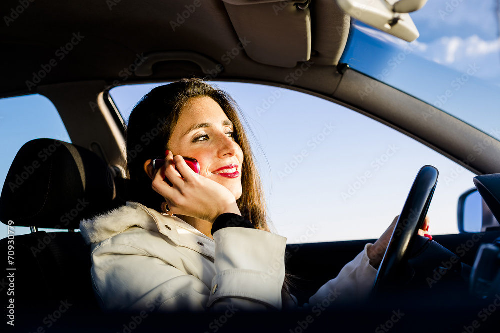 Woman using mobile phone while she is driving Woman using mobile phone while she is driving