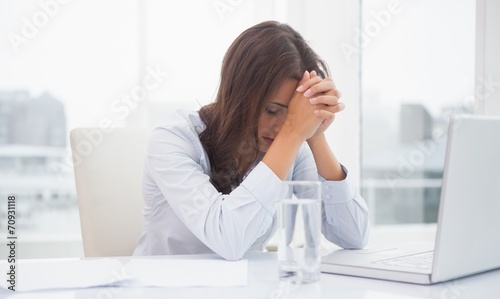 Tired businesswoman sitting at her desk © WavebreakmediaMicro