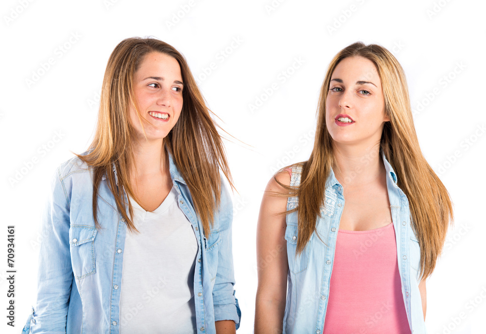 Sisters over isolated white background Sisters over isolated white background