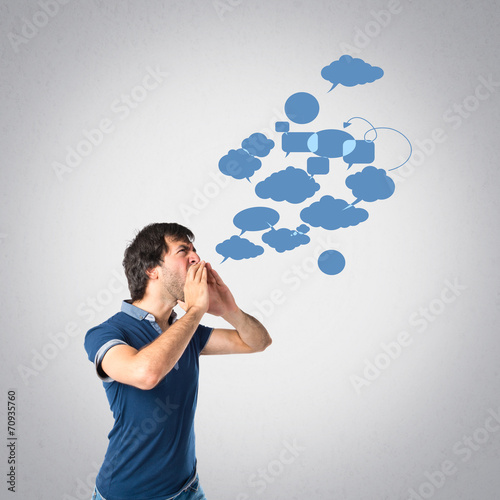 Man shouting over grey background