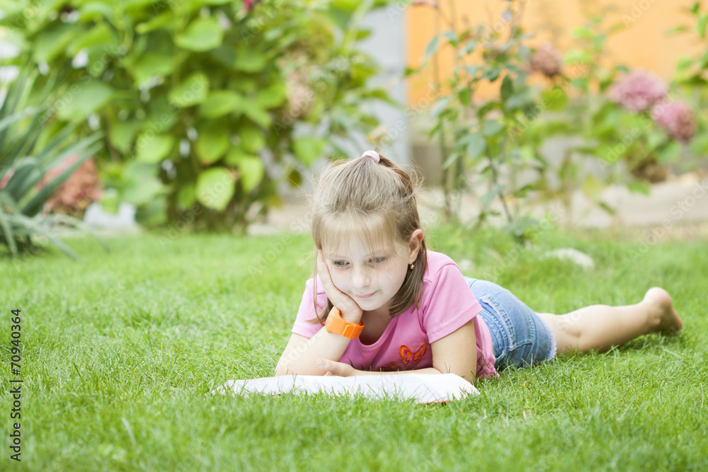 Girl reading a book in the park Girl reading a book in the park
