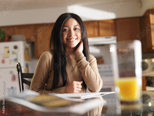teen girl with notebooks and breakfast before school