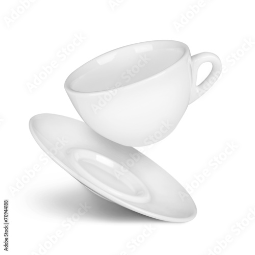 falling coffee cup and saucer on the isolated white background