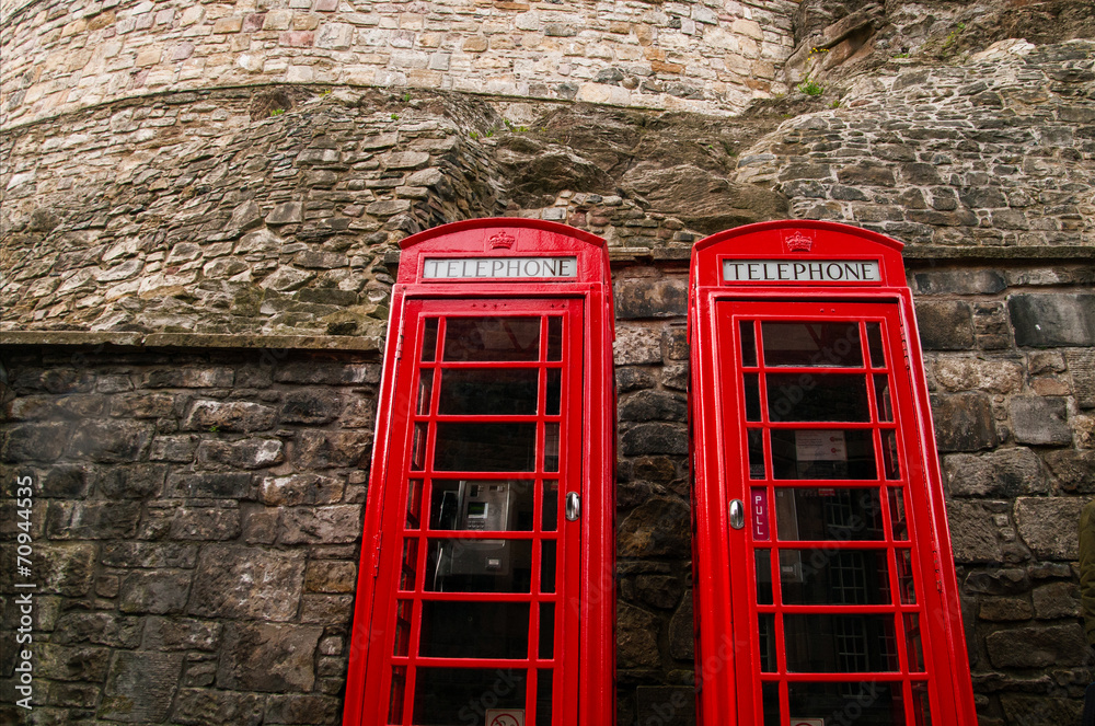 Obraz premium Two red british telephone booths