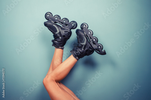 Legs of woman wearing rollerblades photo
