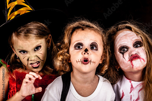 brother and two sisters on  Halloween party