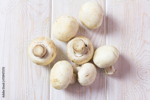 Champignon on wooden background