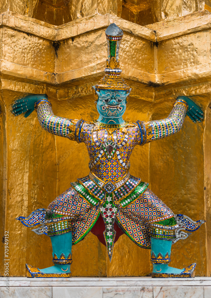 Colourful giant statue around golden pagoda at Wat Phra Kaew