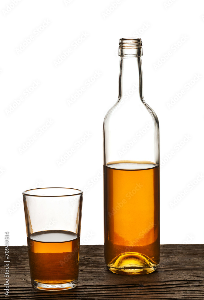 glass and bottle of brandy isolated on the white glass and bottle of brandy isolated on the white