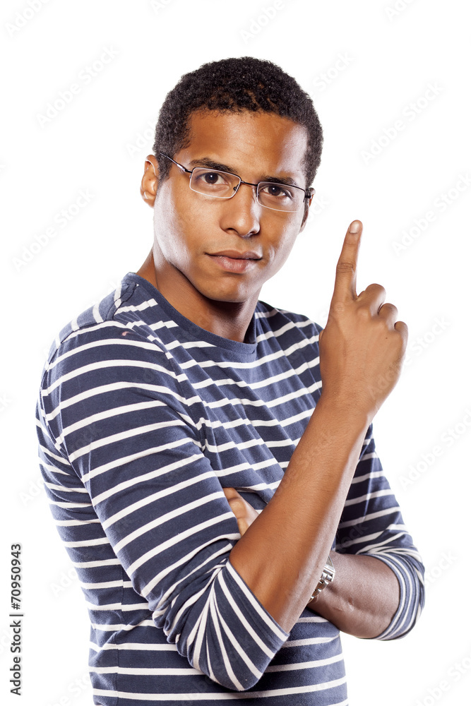 serious dark-skinned young man with glasses shows a finger up serious dark-skinned young man with glasses shows a finger up