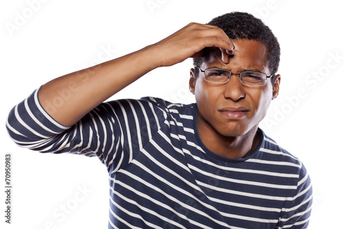 unsure dark-skinned young man with glasses try to focus